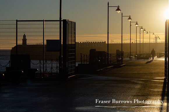 Man walking at sunrise - Harbour Arm - Folkestone